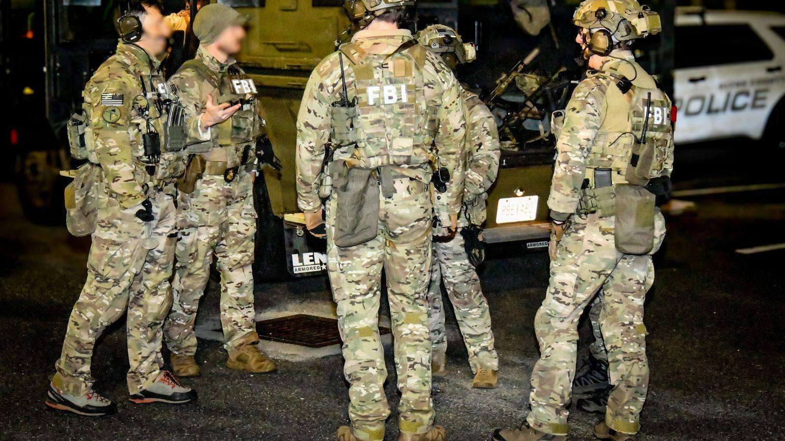 FBI agents and partner-agency SWAT teams staging during a real multi-agency arrest operation