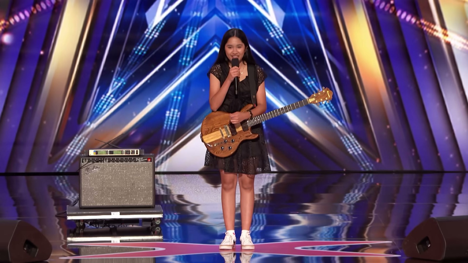 Nene Royal standing on the America's Got Talent audition stage with her guitar and microphone before performing The Cranberries' 'Zombie'