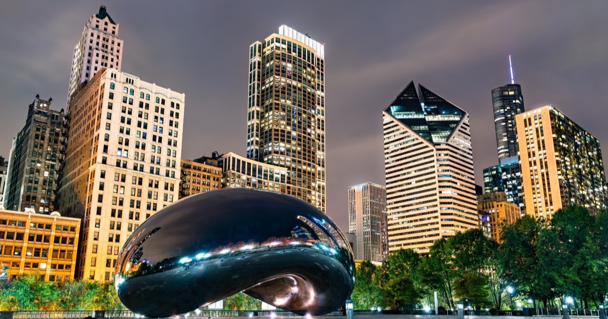 Chicago's Cloud Gate (&ldquo;The Bean&rdquo;) at Millennium Park at night, the downtown skyline reflected in its polished surface